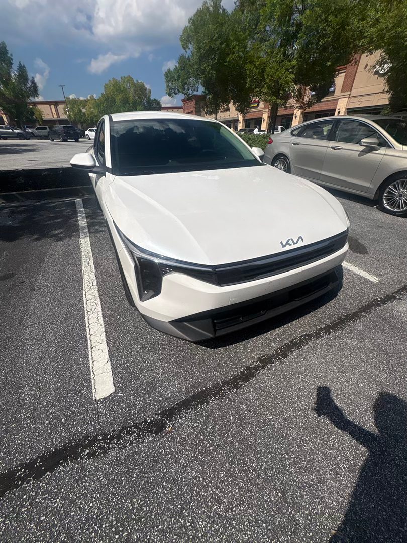 2026 Kia K4 LXS in white, front three-quarter view